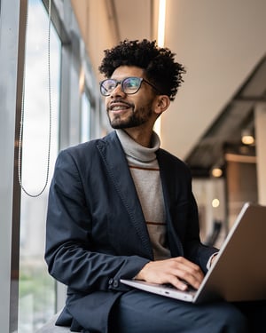 Businessman-contemplating-in-the-office-looking-through-the-window-800x1000