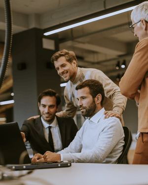 Group-of-business-people-with-young-adults-and-senior-woman-colleague-on-meeting-at-modern-bright-office-interior-800x1000